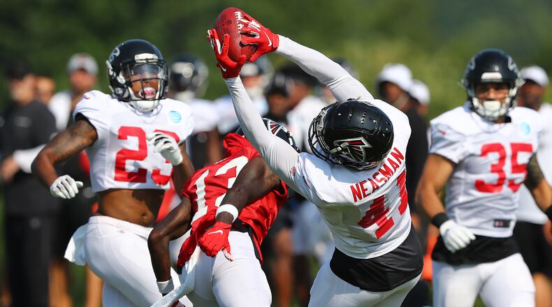 Falcons safety Sharrod Neasman goes up for an interception against the offense during team practice Monday, July 29, 2019, in Flowery Branch.