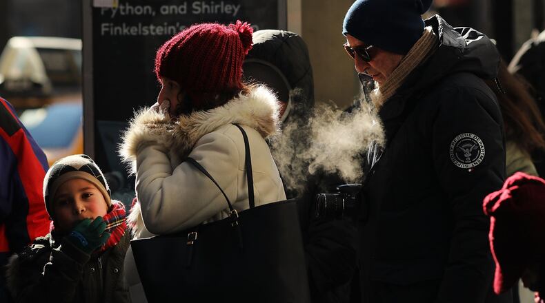 People walk through a frigid Manhattan on December 28, 2017 in New York City. Dangerously low temperatures and wind chills the central and eastern United States are making outdoor activity difficult for many Americans. Little relief from the below normal temperatures is expected the first week of the New Year. (Photo by Spencer Platt/Getty Images)