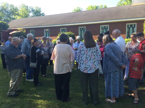 A group from Florida listens as Maranatha Baptist Church member Jan Williams (center, back to camera) tells them there won’t be room for all of them to get into Jimmy Carter’s Sunday school class on May 6, 2018. More than 50 of them had come by bus from Florida and arrived by 7 a.m. JILL VEJNOSKA / JVEJNOSKA@AJC.COM