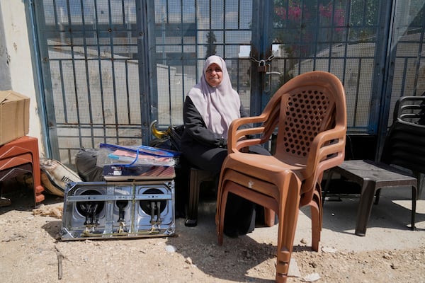 Residents of the now evacuated refugee camp of Tulkarem return to collect belongings before the destruction of their homes as Israeli forces prepare to carry out the demolition of 116 homes across the two refugee camps of the Israeli occupied West Bank city of Tulkarem, Friday, May 2, 2025. (AP Photo/Nasser Nasser)
