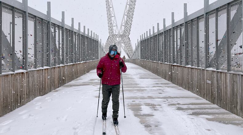 Jacob Coleman skis across SkyDance Bridge over Interstate 40 during a snowstorm in Oklahoma City on Saturday, Jan. 24, 2026. (AP Photo/Thomas Peipert)