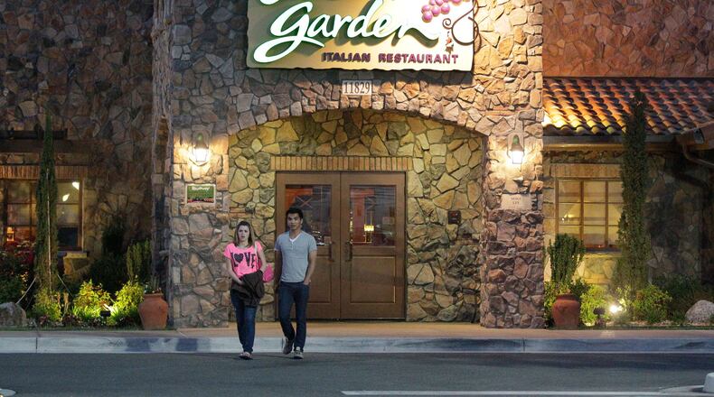 FILE - In this May 22, 2014, file photo, patrons exit an Olive Garden restaurant, a Darden brand, in Short Pump, Va. On Tuesday, April 5, 2016, Darden reports financial results. (AP Photo/Steve Helber, File) ORG XMIT: NYBZ228