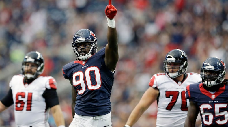 Houston Texans' Jadeveon Clowney (90) celebrates after he sacked Atlanta Falcons' Matt Ryan during the first quarter of an NFL preseason football game Saturday, Aug. 16, 2014, in Houston. (AP Photo/Patric Schneider)