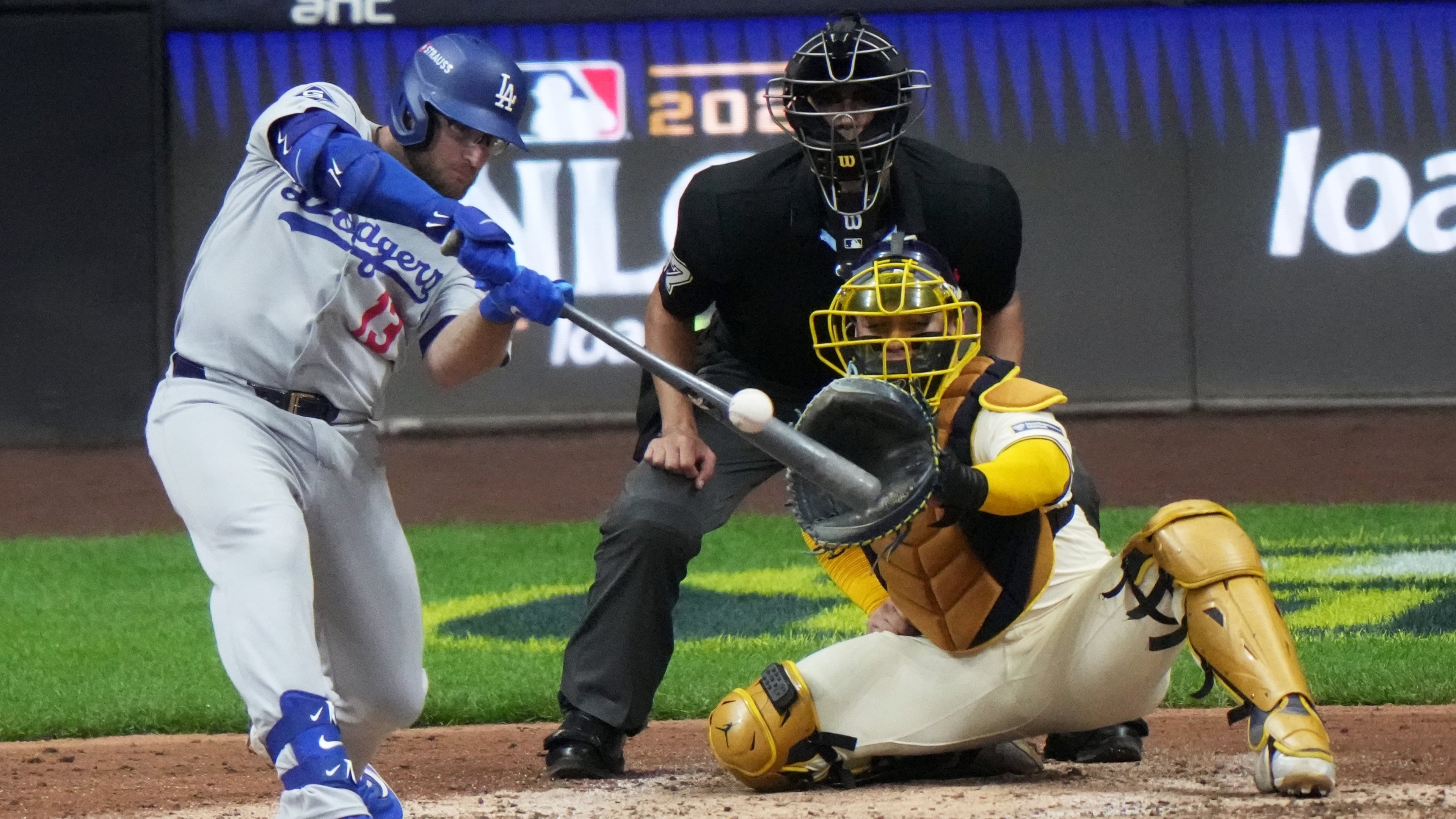Los Angeles Dodgers' Max Muncy hits a home run during the sixth inning of Game 2 of baseball's National League Championship Series against the Milwaukee Brewers Tuesday, Oct. 14, 2025, in Milwaukee. (AP Photo/Morry Gash)