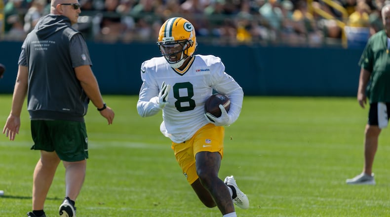 Green Bay Packers running back Josh Jacobs (8) runs with the ball during a drill at the NFL football team's training camp, Sunday, Aug. 2, 2026, in Green Bay, Wis. (AP Photo/Mike Roemer)
