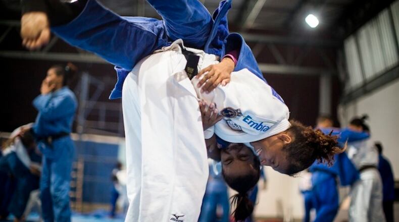 Rafaela Silva, in white, who grew up in the Cidade de Deus (City of God) slums of Rio de Janeiro, spars at a gym in the city, where she began training in judo as a child, Nov. 12, 2015. Silva, who was disqualified from the 2012 London Olympics but was World Champion in the sport in 2013, will compete in this summer's Olympics in Rio. (Leslye Davis/The New York Times)