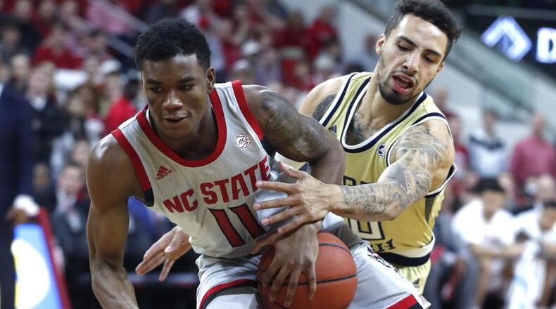 North Carolina State's Markell Johnson (11) drives around Georgia Tech's Jose Alvarado (10) during the first half of an NCAA college basketball game in Raleigh, N.C., Wednesday, March, 6, 2019. (Ethan Hyman/The News & Observer via AP)