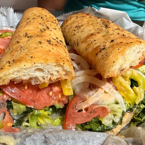 A large Italian sandwich wrapped in paper.