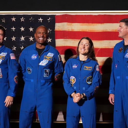 Artemis II crew members Reid Wiseman, from left, Victor Glover, Christina Koch and Jeremy Hansen stand as President Donald Trump speaks during Salute to America, an Independence Day event honoring the nation's 250th anniversary, Saturday, July 4, 2026, on the National Mall in Washington. (AP Photo/Mark Schiefelbein)