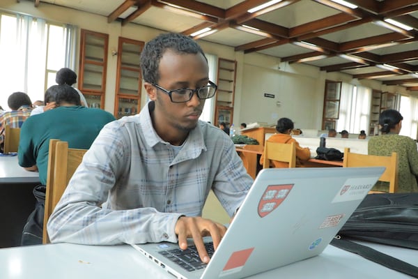 Yonas Nuguse, 21 years old, destined for Harvard University working on a computer at Wemezeker National Library in Addis Ababa, Ethiopia Friday, May 30, 2025. (AP Photo/Amanuel Birhane)