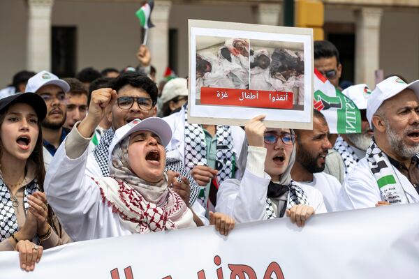 People take part in a demonstration in Rabat, Morocco, Sunday, April 6, 2025 as they protest Israel’s latest offensive in Gaza and U.S. President Donald Trump's proposal to displace Palestinians and clear the territory for development. The placard in Arabic reads "Save Gaza's children." (AP Photo)