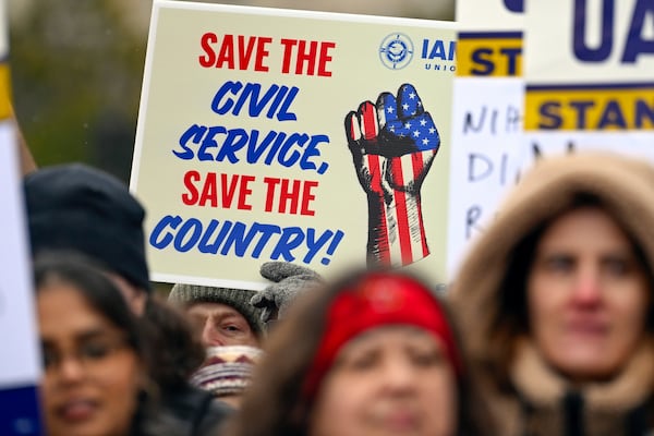 FILE - People rally at Health and Human Services headquarters to protest the polices of President Donald Trump and Elon Musk Wednesday, Feb. 19, 2025, in Washington. (AP Photo/John McDonnell, file)