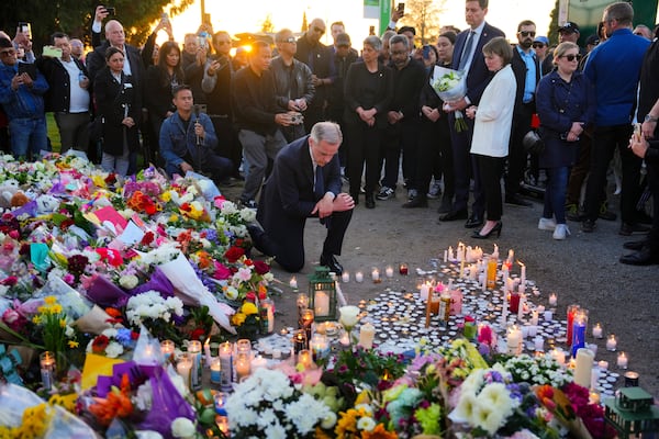 Liberal Leader Mark Carney takes a moment after lighting a candle at a memorial for victims after a vehicle drove into a crowd during a Filipino heritage festival in Vancouver, British Columbia, Sunday, April 27, 2025. (Sean Kilpatrick/The Canadian Press via AP)