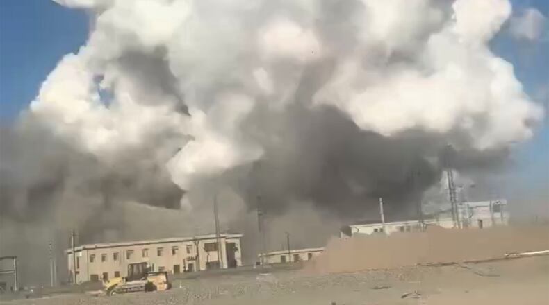 In this photo released by Xinhua News Agency, smoke rises from the site of explosions from a factory in Baotou, in north China's Inner Mongolia Autonomous Region, Sunday, Jan. 18, 2026. (Xinhua via AP)