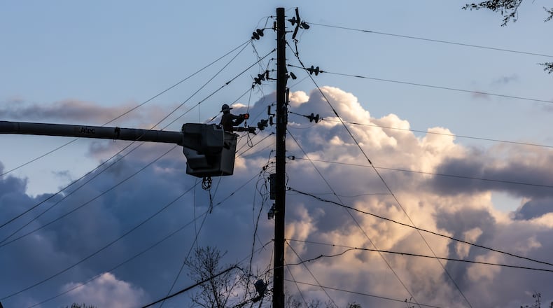 Crews work to restore power after stormy weather on McDaniel Mill Road in Conners on April 3. (John Spink / John.Spink@ajc.com)