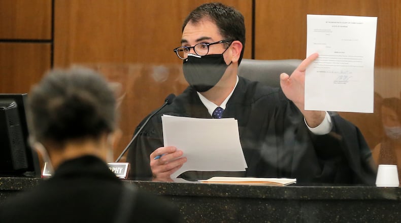Chief Magistrate Judge Brendan Murphy in a discussion with a landlord and tenant in a mid-August hearing at the Cobb County Magistrate Court in Marietta. (Christine Tannous / christine.tannous@ajc.com)