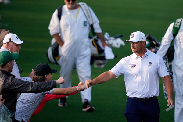 Bryson DeChambeau greets patrons on the 18th hole during the third round at the Masters golf tournament, Saturday, April 12, 2025, in Augusta, Ga. (AP Photo/Julia Demaree Nikhinson)