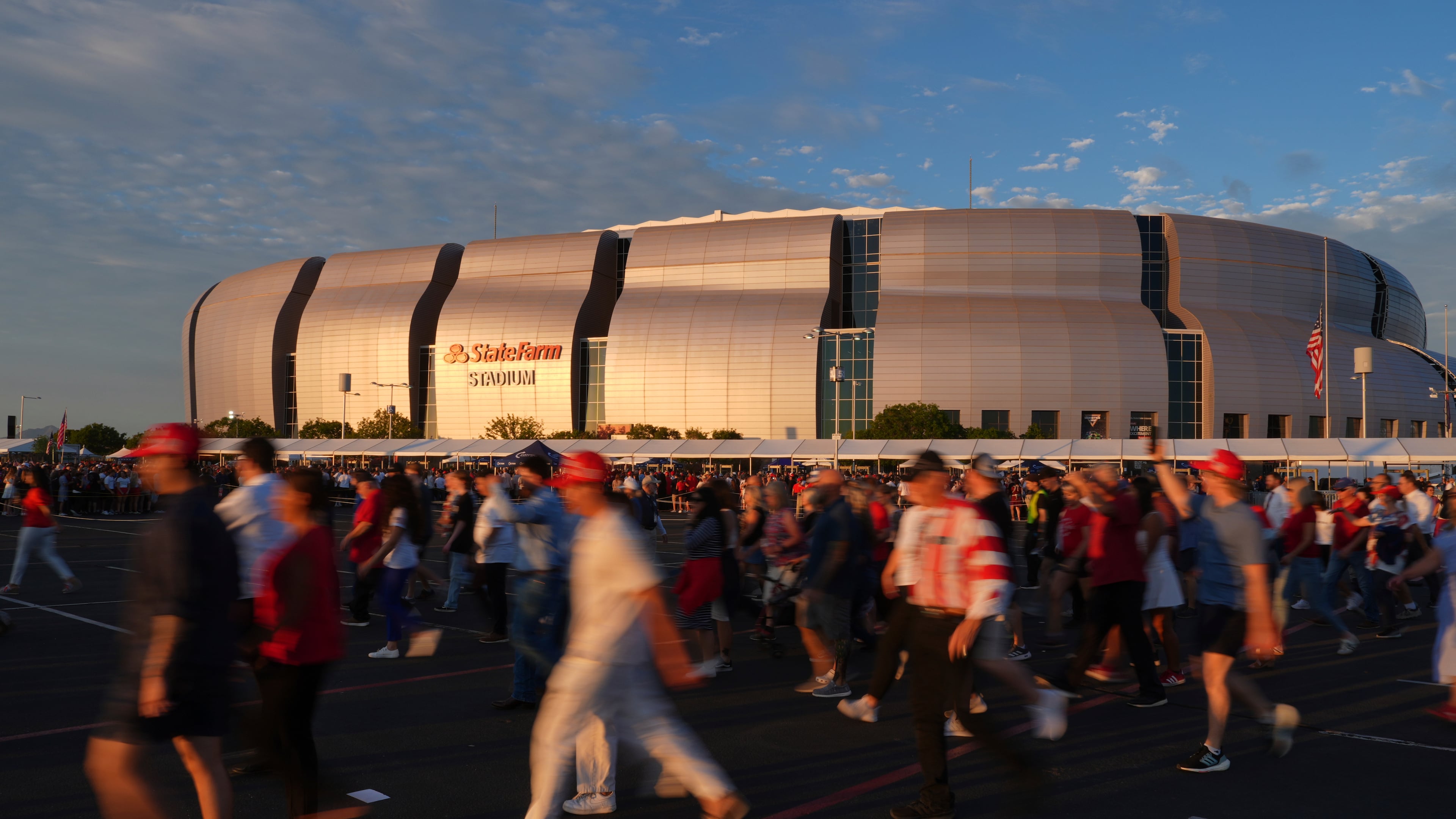 People wait in line before a memorial for conservative activist Charlie Kirk Sunday, Sept. 21, 2025, at State Farm Stadium in Glendale, Ariz. (AP Photo/Jae C. Hong)