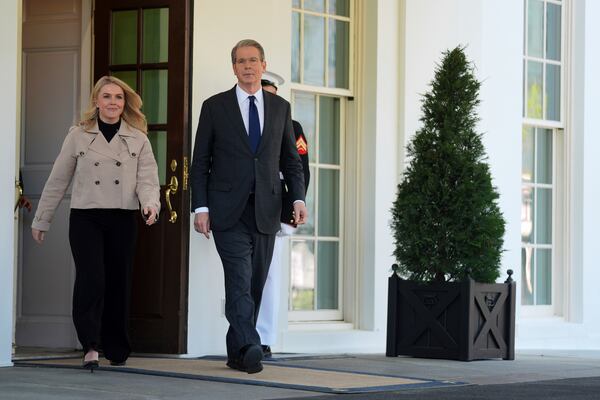 Treasury Secretary Scott Bessent and White House press secretary Karoline Leavitt walk to speak with reporters outside the West Wing of the White House, Wednesday, April 9, 2025, in Washington. (AP Photo/Evan Vucci)
