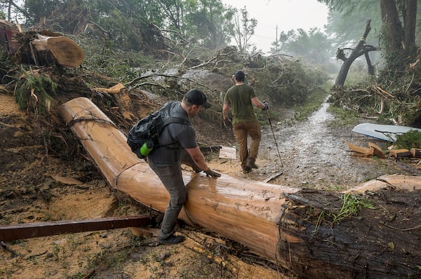 Volunteers search for missing people along the banks of the Guadalupe River after recent flooding on Sunday, July 6, 2025, in Hunt, Texas. (AP Photo/Rodolfo Gonzalez)