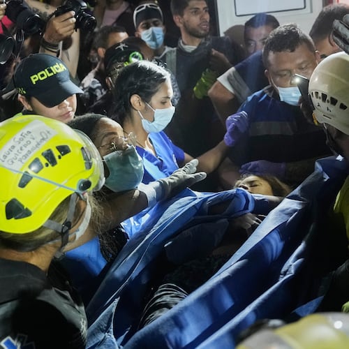Rescue workers carry a survivor Daniela Largo after pulling her from the rubble the day after an earthquake struck Pereira, Colombia, Tuesday, Aug. 11, 2026. (AP Photo/Fernando Vergara)