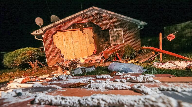 Two people were hurt when a car crashed into this house near Stone Mountain on Mon., Oct. 19, 2015. JOHN SPINK / JSPINK@AJC.COM