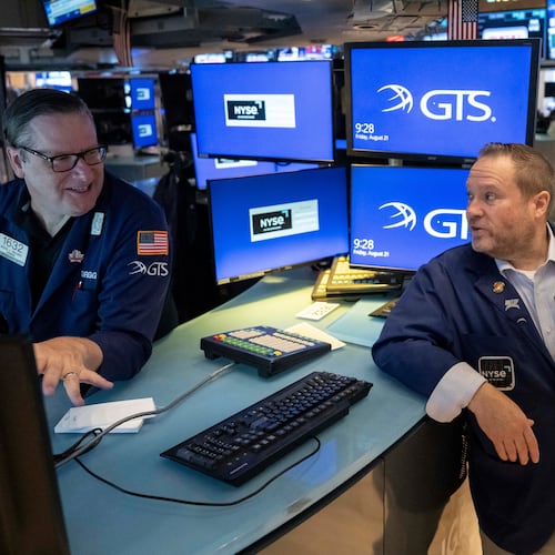 Specialists Gregg Maloney, left, and Michael Shearin work on the floor of the New York Stock Exchange in New York, Friday, Aug. 21, 2026. (AP Photo/Yuki Iwamura)