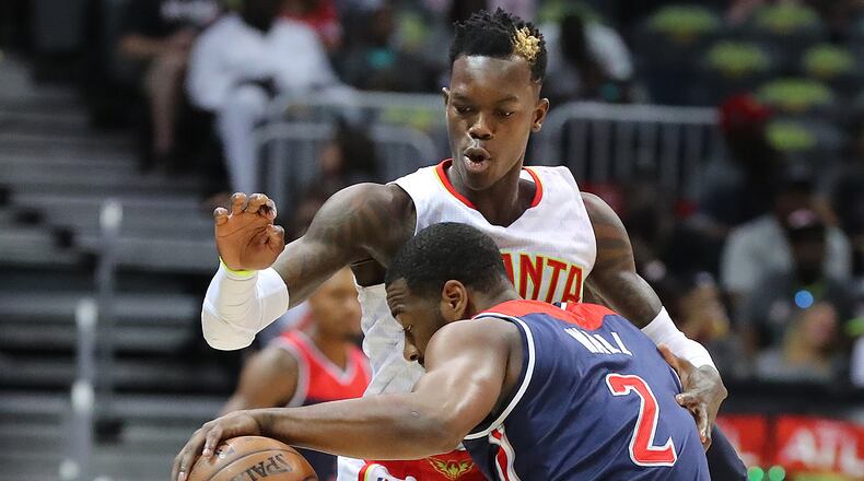 Atlanta Hawks guard Dennis Schroder stops a drive by Washington Wizards guard John Wall in Game 3 of a first-round NBA basketball playoff series on Saturday, April 22, 2017, in Atlanta. The Hawks beat the Wizards 116-98. Curtis Compton/ccompton@ajc.com
