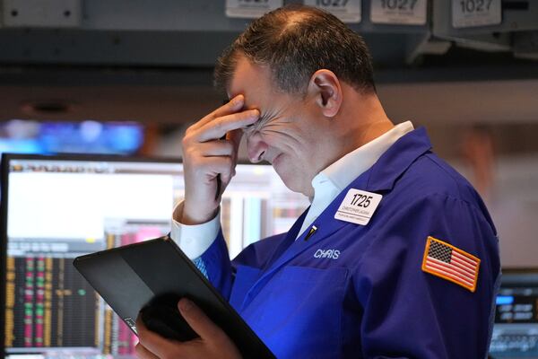 A person works on the floor at the New York Stock Exchange in New York, Monday, March 31, 2025. (AP Photo/Seth Wenig)