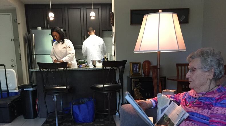 Dolores Lane is glad to stay out of the kitchen while Leslie Chapman (left) and Christopher Watts of Chefs for Seniors prepare meals she ll enjoy for the next two weeks. Photo: C.W. Cameron