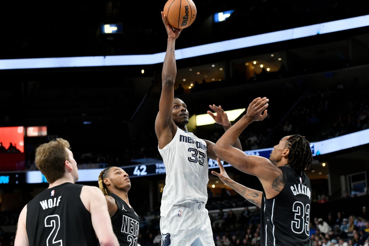 Then-Grizzlies center Christian Koloko (center) shoots over Nets players Danny Wolf (from left), Noah Clowney and Nic Claxton on Sunday, Jan. 11, 2026, in Memphis, Tenn. Koloko has had quite the welcome to Atlanta. (Brandon Dill/AP)