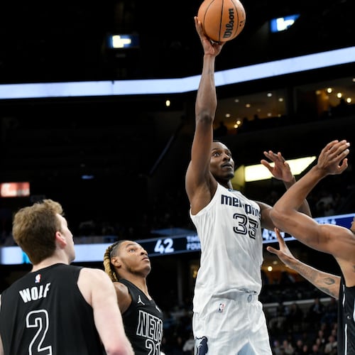 Then-Grizzlies center Christian Koloko (center) shoots over Nets players Danny Wolf (from left), Noah Clowney and Nic Claxton on Sunday, Jan. 11, 2026, in Memphis, Tenn. Koloko has had quite the welcome to Atlanta. (Brandon Dill/AP)