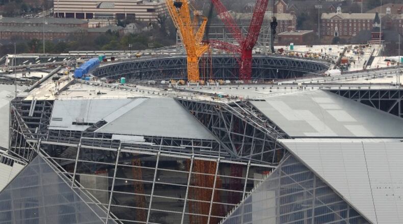 January 10, 2017, Atlanta: The progress of the new Falcons Mercedes-Benz Stadium is seen with cranes rising from the floor through the retractable roof on Tuesday, Jan. 10, 2017, in Atlanta. Curtis Compton/ccompton@ajc.com