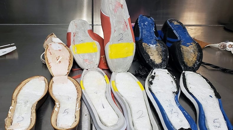 Customs officials said they found $40,000 worth of cocaine hidden in seven pairs of the woman's shoes.