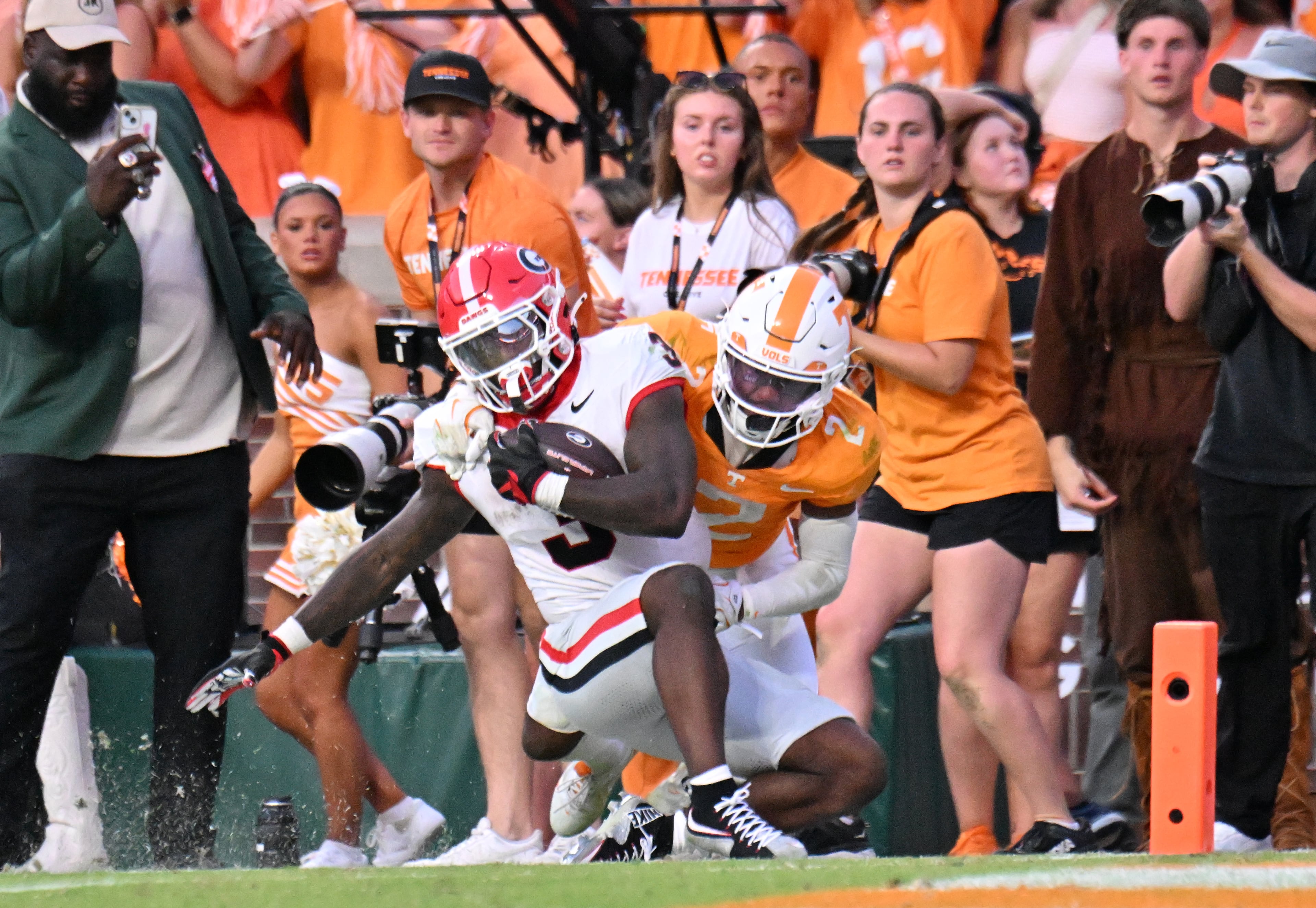 Georgia running back Nate Frazier (front) gets tackled by Tennessee defensive back Andre Turrentine near the end zone during overtime against Tennessee at Neyland Stadium on Saturday, Sept. 13, 2025, in Knoxville, Tenn. Georgia won 44-41 in overtime. (Hyosub Shin/AJC)