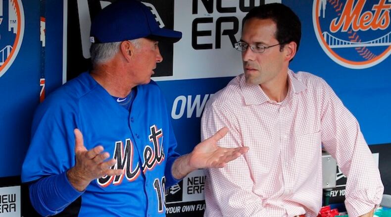 FILE - In this Aug. 8, 2011, file photo, New York Mets manager Terry Collins talks with Mets VP of Player Development Paul DePodesta in the dugout before a game against the San Diego Padres in New York. Cleveland Browns owner Jimmy Haslam has brought in Paul DePodesta, a baseball executive and analytics expert with 20 years of major league experience, to be the NFL team's new chief strategy officer. Haslam, who fired coach Mike Pettine and general manager Ray Farmer on Sunday night, Jan. 3, 2016, following a 3-13 season, pulled DePodesta away from the New York Mets to help his organization with decision making. (AP Photo/Paul J. Bereswill, File)