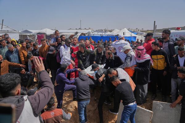 Mourners carry the bodies of 8 Red Crescent emergency responders, recovered in Rafah a week after an Israeli attack, during their funeral in Deir al-Balah, Gaza Strip, on Mon day, March 31, 2025. (AP Photo/Abdel Kareem Hana)