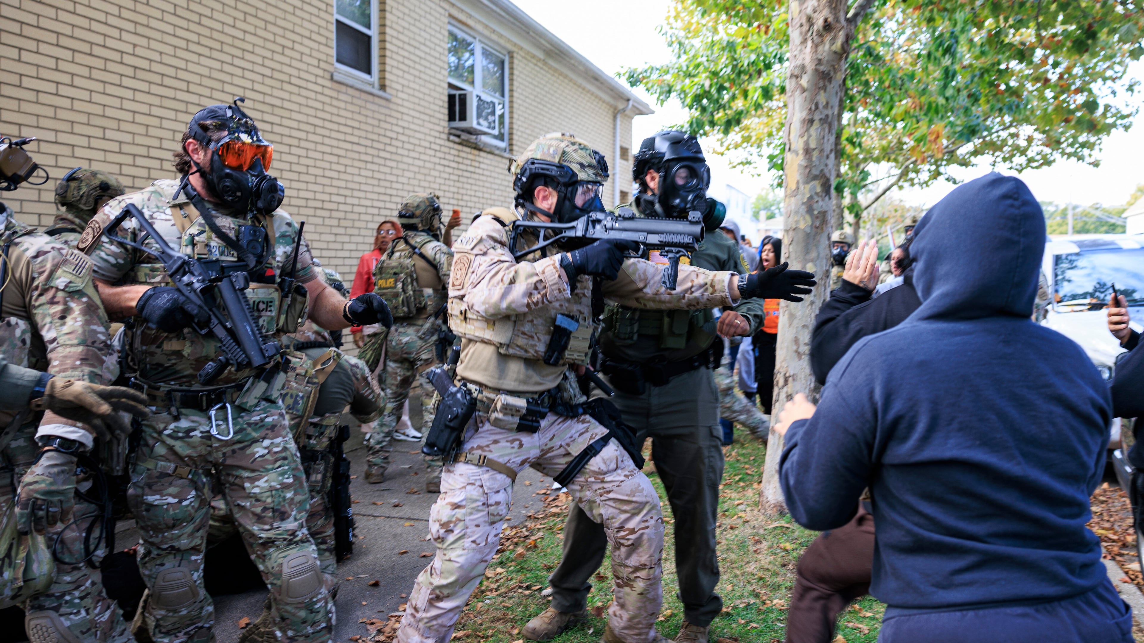 Government officials push back protesters in Chicago, Tuesday, Oct. 14, 2025. (Anthony Vazquez/Chicago Sun-Times via AP)