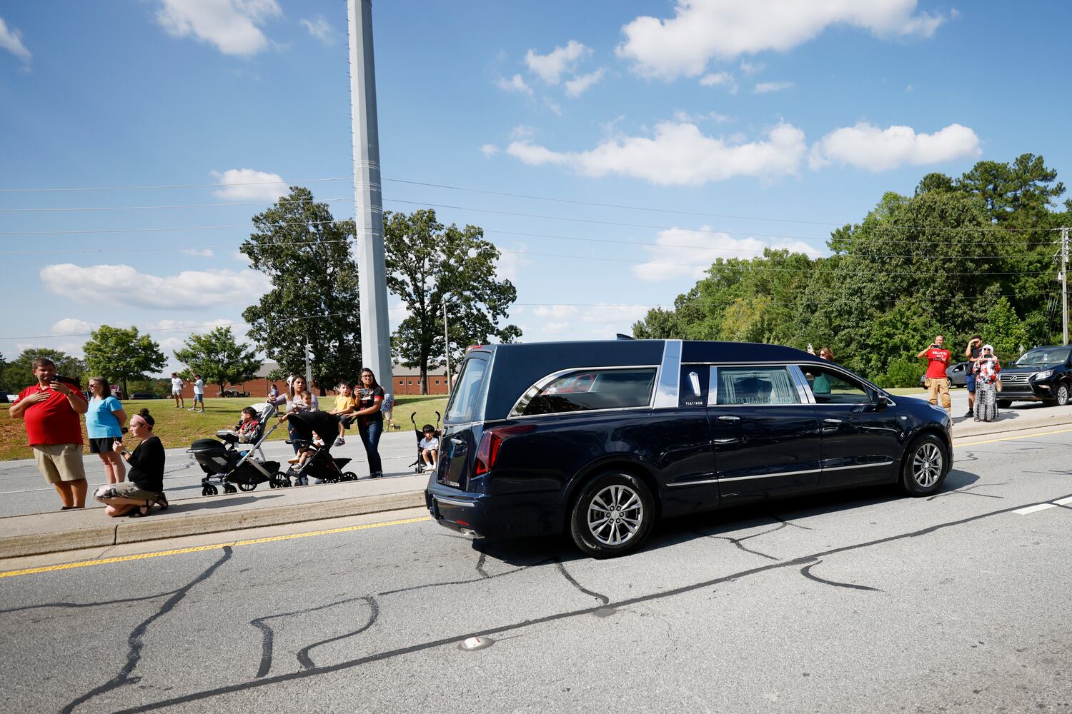 The hearse carrying the fallen Marshall Samual Ervin Jr travels by Dallas Highway on Thursday, September 15, 2022. Marshall Samual Ervin Jr, alongside Sheriff Deputy Koleski, was killed late Thursday while attempting to arrest Christopher James Cook Jr. at home in the Hampton Glen subdivision last Thursday. Miguel Martinez / miguel.martinezjimenez@ajc.com