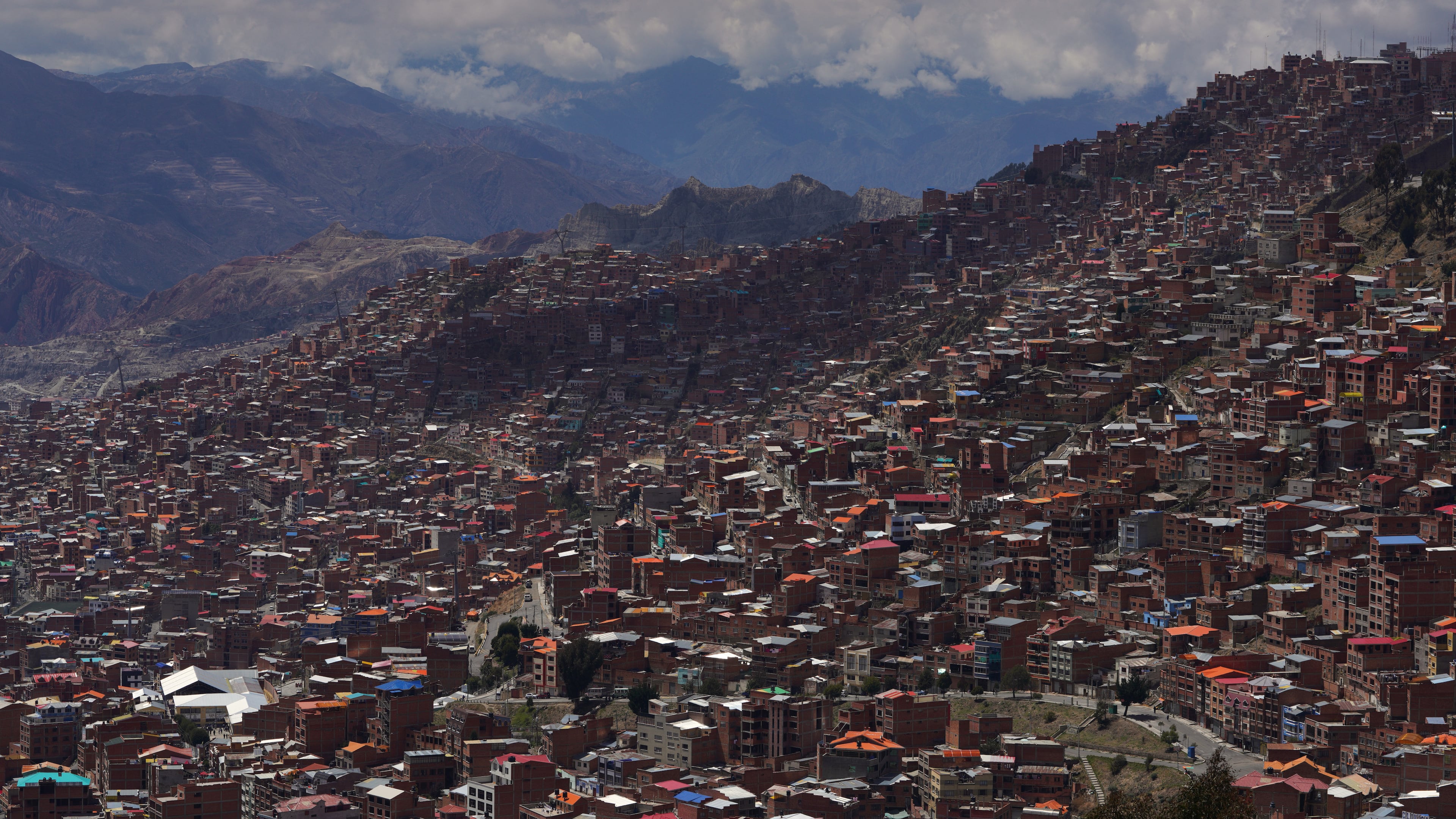 FILE - Clouds hang over the mountains surrounding La Paz, Bolivia, Oct. 19, 2025. (AP Photo/Ivan Valencia, File)