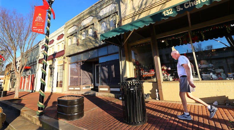 A local resident makes his way through Social Circle's mostly quiet main street commercial district on Tuesday, Jan. 18, 2022. (Curtis Compton/AJC)