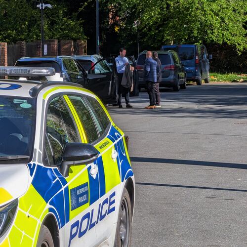 Police officers patrol at a cordon near Kenton United Synagogue in Harrow, a suburb of London, Sunday, April 19, 2026. (Jamie Lashmar/PA via AP)