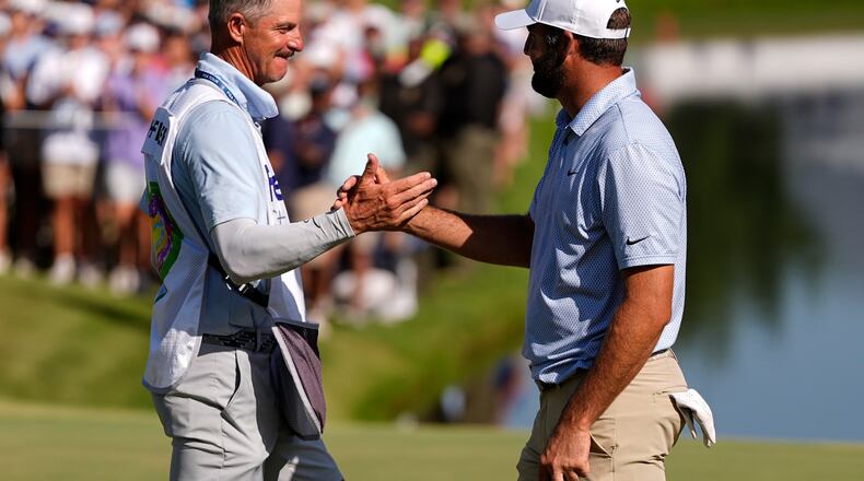 Scottie Scheffler celebrates winning on the 18th green the final round of the St. Jude Championship golf tournament, Sunday, Aug. 16, 2026, in Memphis, Tenn. (AP Photo/George Walker IV)