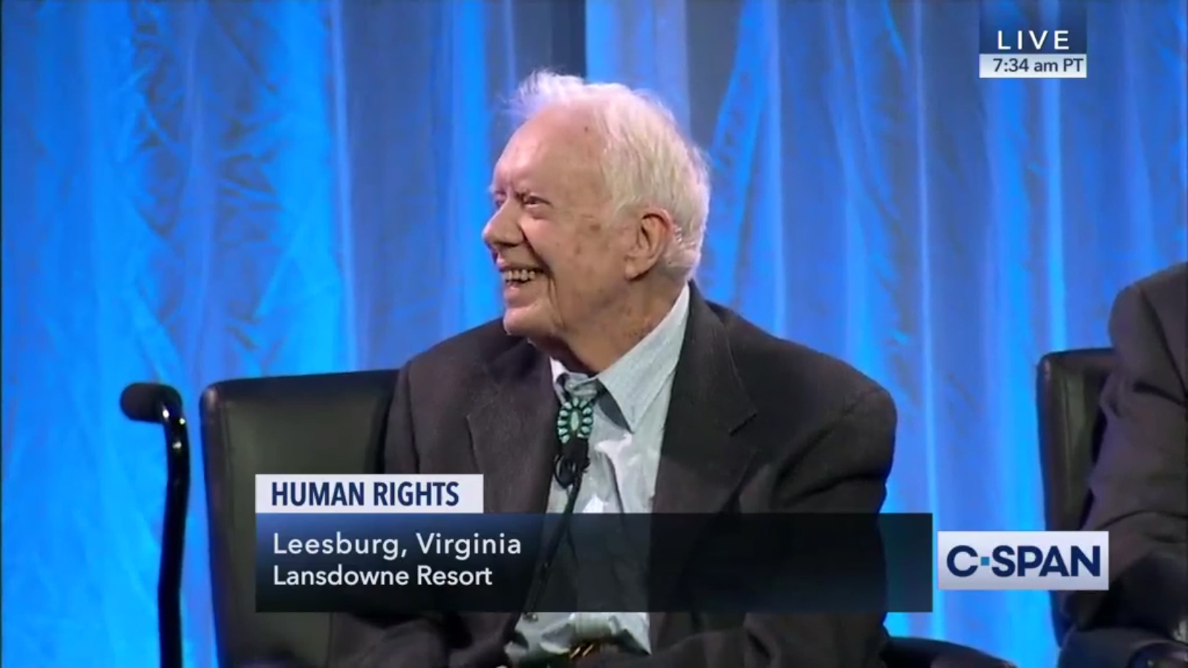 President Jimmy Carter smiles after saying that President Donald Trump was elected with help from Russia, during a panel discussion on human rights at a resort in Leesburg, Virginia. The panel was moderated by historian Jon Meacham and included former Vice President Walter Mondale.