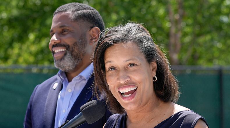 District of Columbia Mayor Muriel Bowser, right, speaks as Delano Hunter, director of the DC Department of General Services, left, listens during the opening of the newly renovated outdoor pool at the Rosedale Recreation Center, Thursday, July 23, 2026, in Washington. (AP Photo/Mariam Zuhaib)