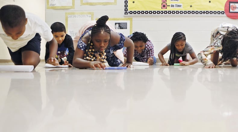 Third graders race “puffmobiles” they built, which are powered by blowing on them, as part of a science project in Atlanta Public Schools’ redesigned summer school program, called Power Up. At Peyton Forest Elementary School, students take part in a program that focuses on science, technology, engineering, fine arts, and math skills. APS is following a national trend by rolling out a new summer program model intended to feel less punitive to students and focus more on enrichment than remediation. (Bob Andres / bandres@ajc.com)