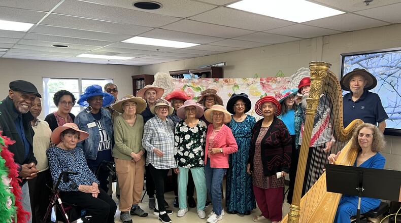 Crabapple Senior Center participants with harpist Lisa Handman in one of the many programs provided through Fulton County Senior Services. (Courtesy of Senior Services North Fulton)