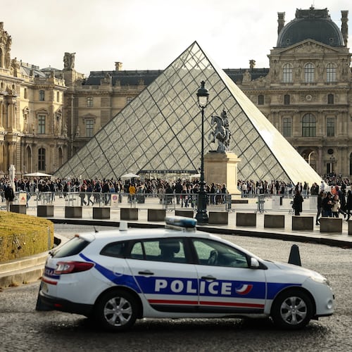 A police car parks in the courtyard of the Louvre museum, one week after the robbery, Sunday, Oct. 26, 2025 in Paris. The Paris prosecutor said on Sunday that a number of suspects have been arrested over the theft of crown jewels from Paris' Louvre museum last weekend. (AP Photo/Thomas Padilla)