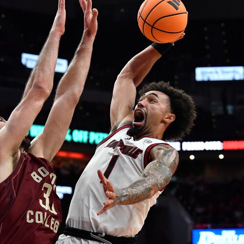Louisville guard J'vonne Hadley (1) goes in for a dunk against Boston College center Boden Kapke (33) during the second half of an NCAA college basketball game in Louisville, Ky., Saturday, Jan. 10, 2026. (AP Photo/Timothy D. Easley)