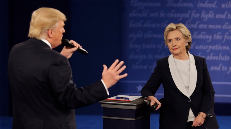 Democratic presidential nominee Hillary Rodham Clinton listens to Republican presidential nominee Donald Trump during the second presidential debate at Washington University in St. Louis on Sunday, Oct. 9, 2016. (John Locher/AP)